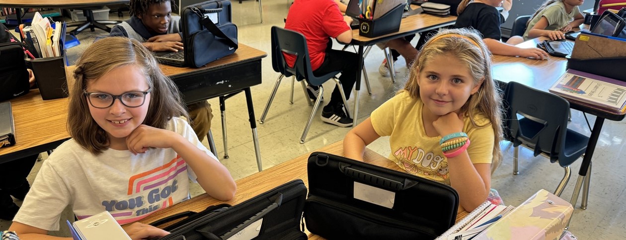 two students working with their Chromebooks