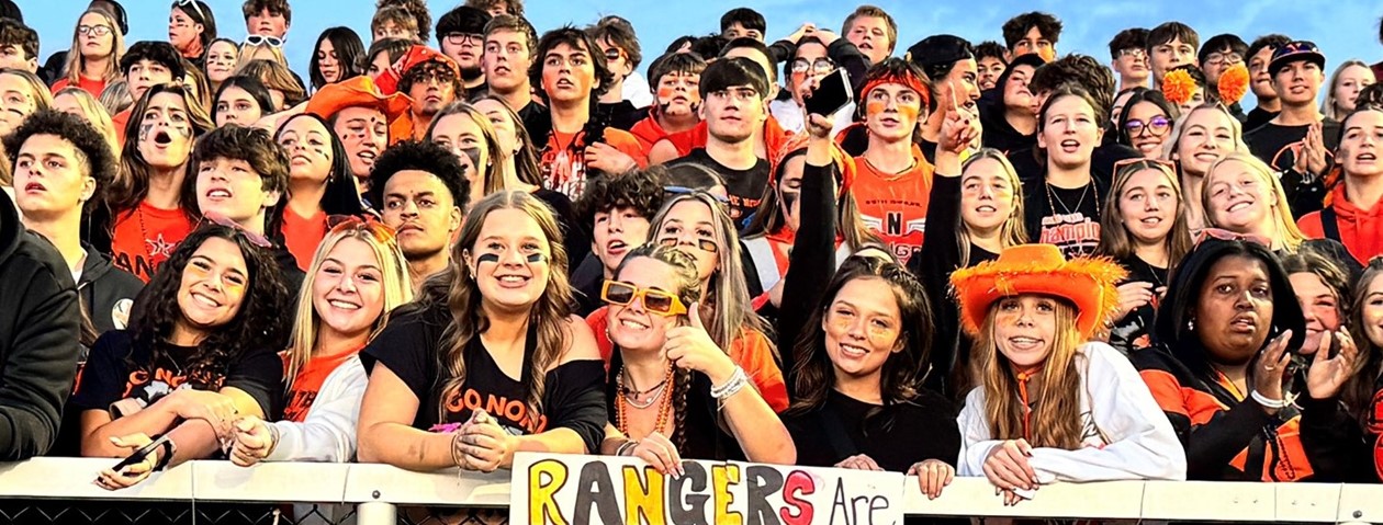 student section cheering at the football game