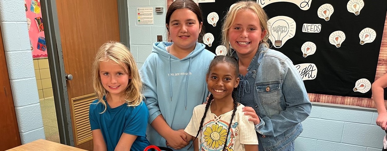 Four students showing makerspace project