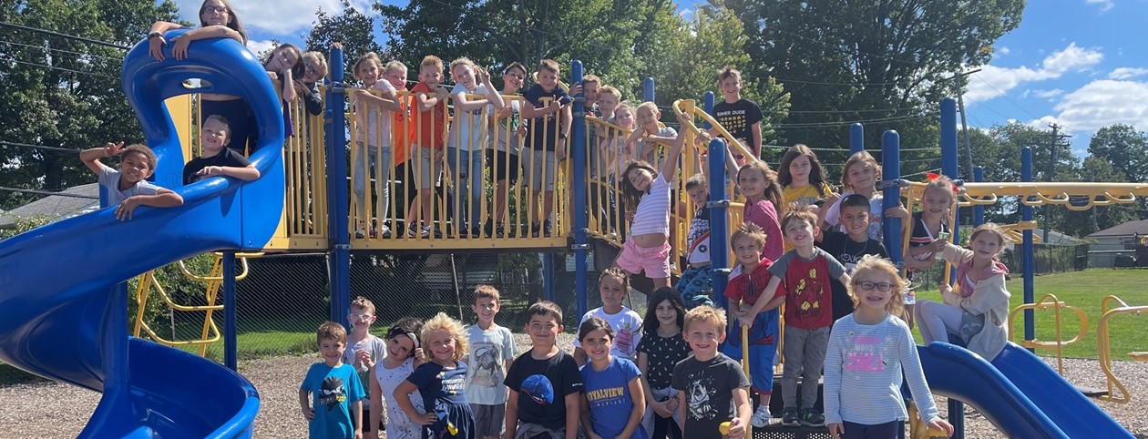 Students posing on a playground