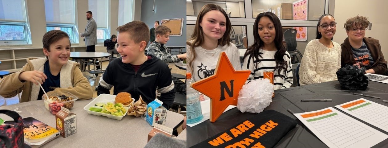 Two middle school boys laughing in the cafeteria. North students at an Experience Night booth.