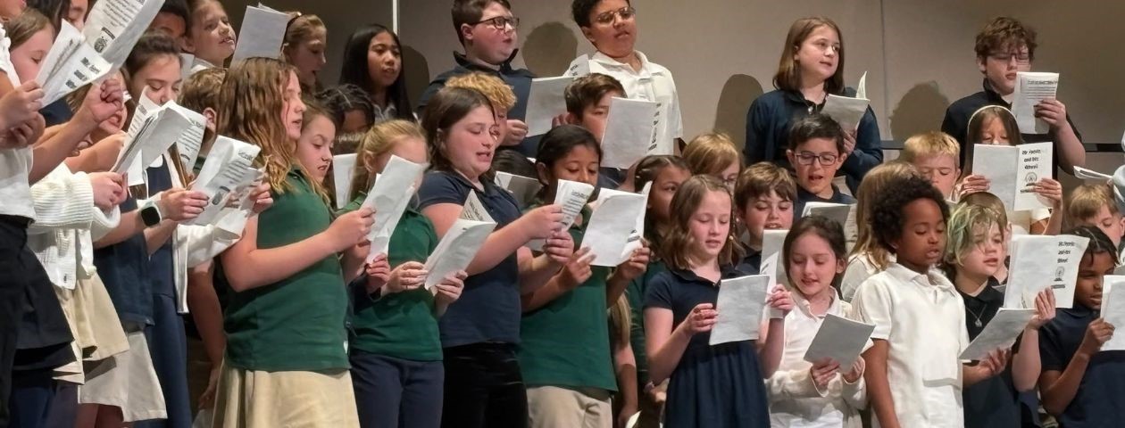 School of Innovation third graders singing on the music risers at a concert